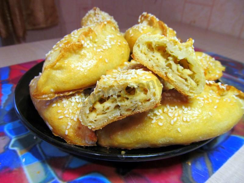Обложка рецепта Пирожки с брынзой и зеленью закусочные в духовке